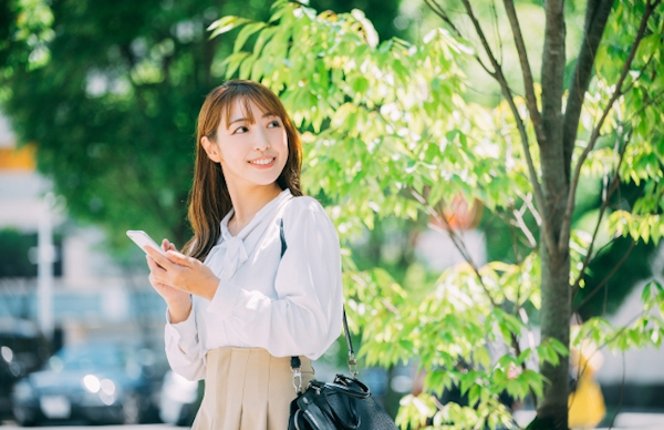 笑顔で待ち合わせをする女性
